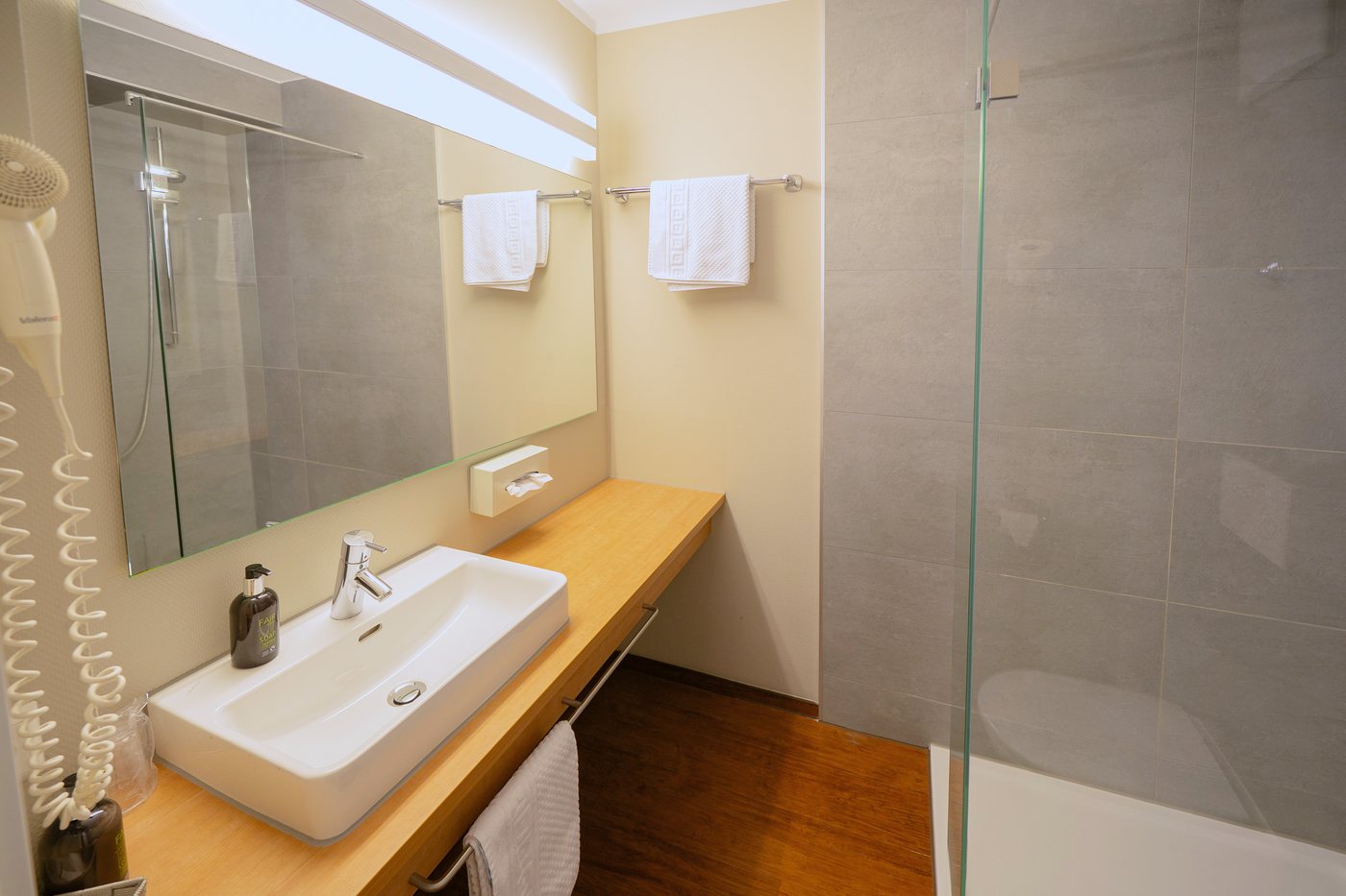 Modern bathroom with shower at Sebcity Hotel